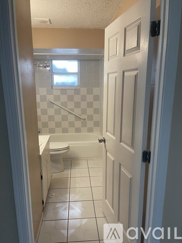 A bathroom with a toilet, sink and bathtub.