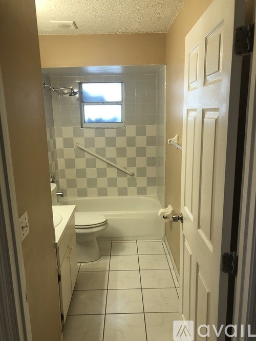 A bathroom with a checkered shower and white toilet.