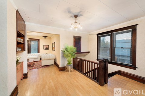 A living room with a white sofa and a wooden floor.