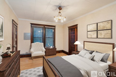 A bedroom with a large bed, a chair, and a ceiling fan.