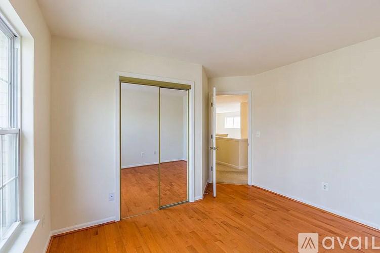 A room with a sliding door and wooden floors.