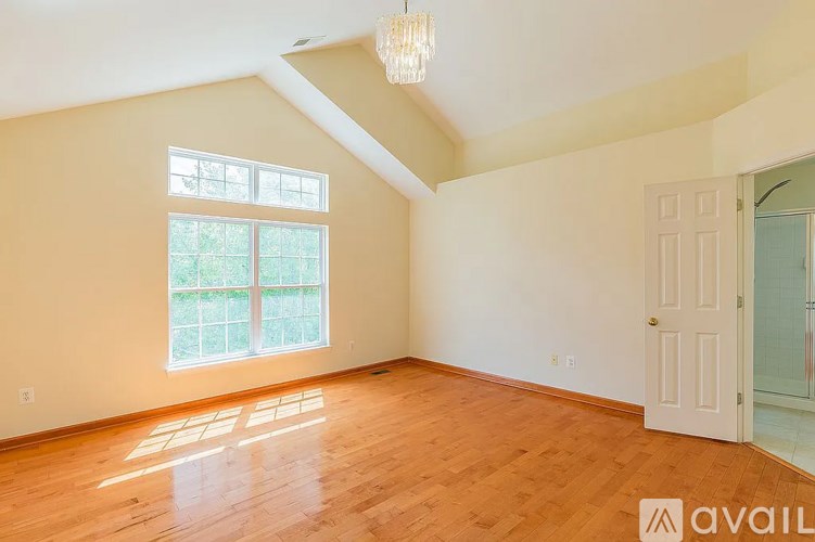 A room with wooden floors and a large window.