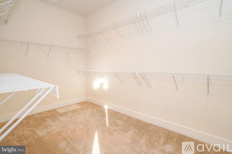 Empty room with white shelves and a brown floor.