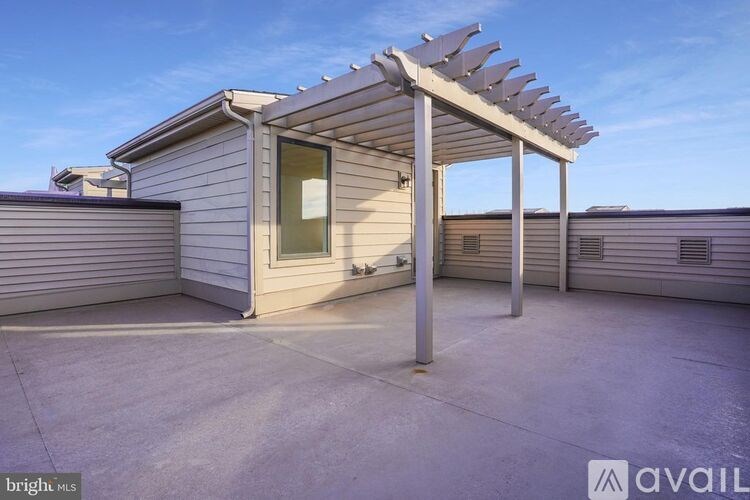 A sunroom with a pergola attached to it.