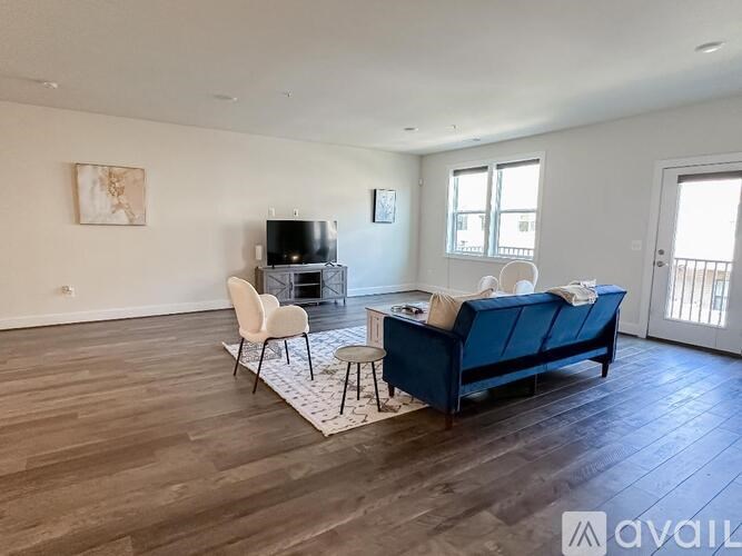 A living room with a blue couch and a television.