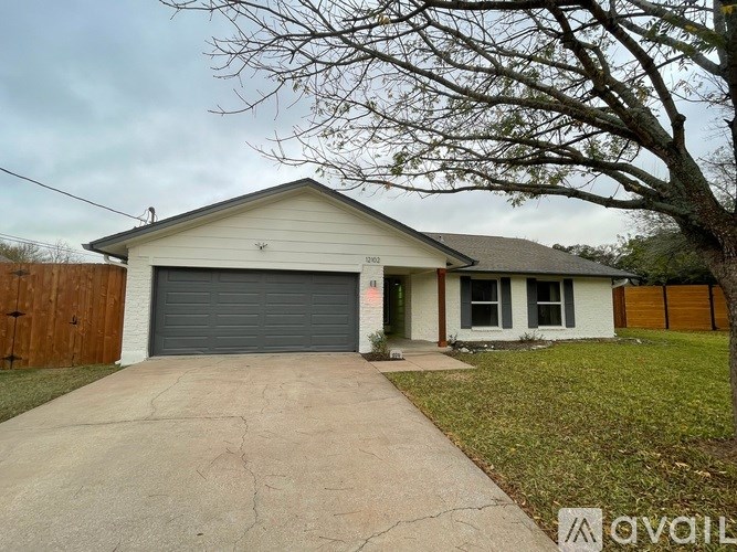 A house with a grey garage door is for sale.