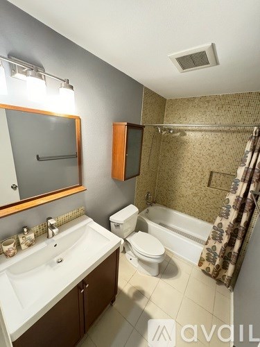 A bathroom with a toilet, sink, and bathtub.