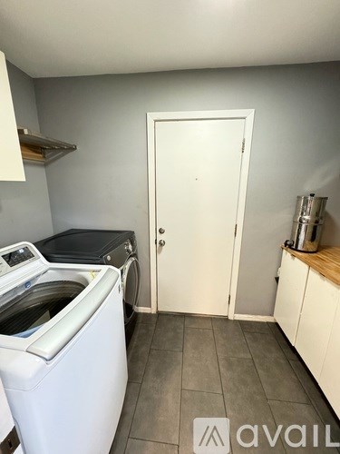 A small laundry room with a washer and dryer.