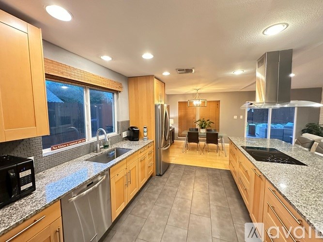 A kitchen with wooden cabinets and granite countertops.