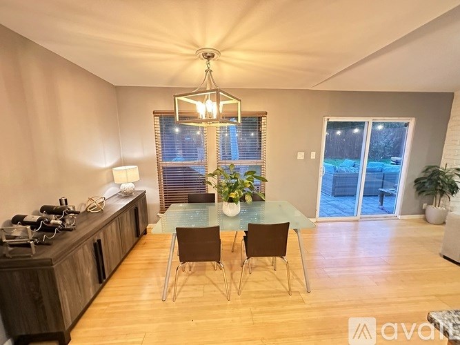 A dining room with a glass table and chairs.