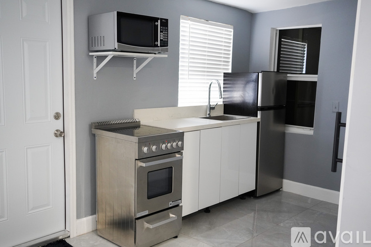 A kitchen with a stainless steel oven and microwave.