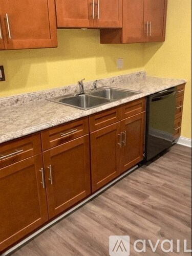 A kitchen with wooden cabinets and a granite countertop.