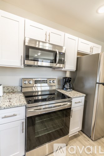 A kitchen with white cabinets and stainless steel appliances.