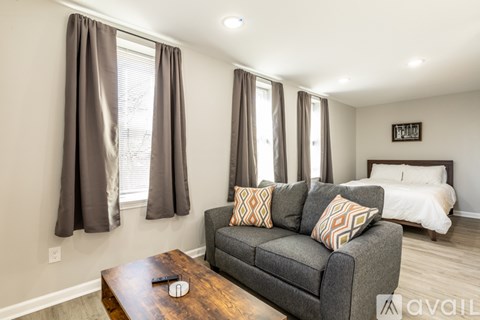 A living room with a grey couch and a wooden coffee table.