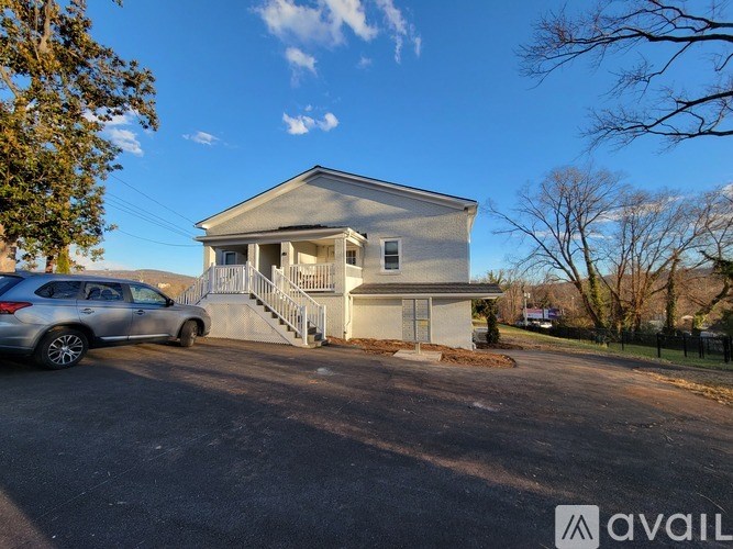 A house with a car parked in front of it.