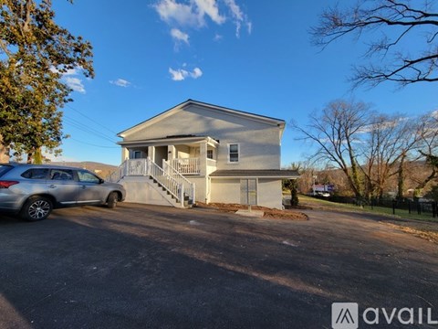 A house with a car parked in front of it.