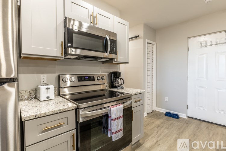 A kitchen with a stainless steel refrigerator, oven, and microwave.