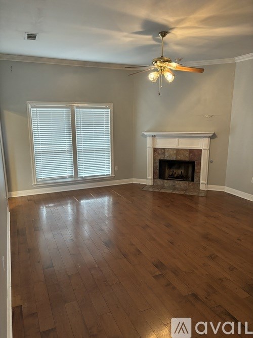 A room with a fireplace and a ceiling fan.