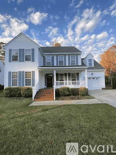 A two-story house with a front porch and a garage.