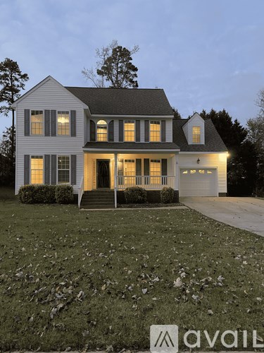 A house with a front yard and a driveway.