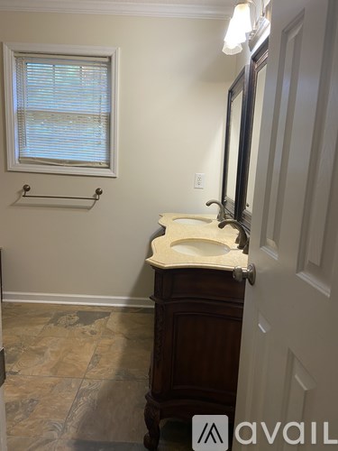 A bathroom with a sink and a window.