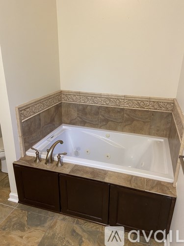 A bathroom with a tub and a counter.