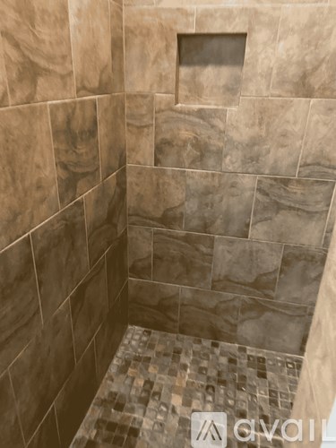 A tiled shower with a brown tile pattern.