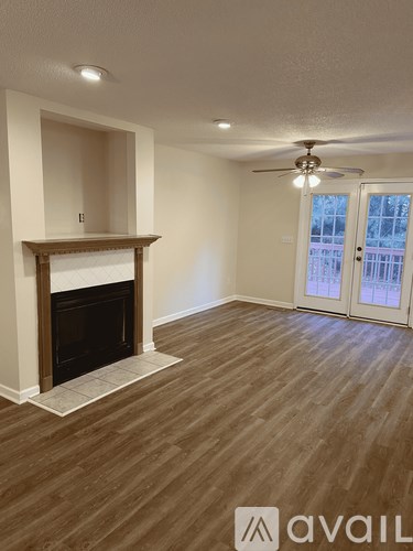 A room with a fireplace and a ceiling fan.
