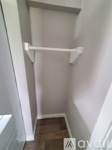 A white shelf in a white room.