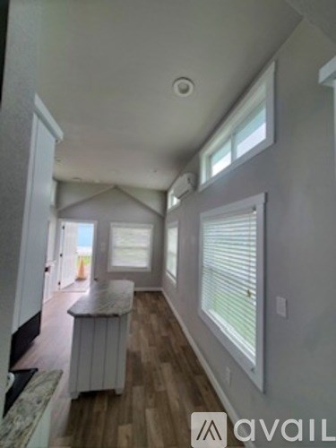 A room with a wooden floor and white walls.