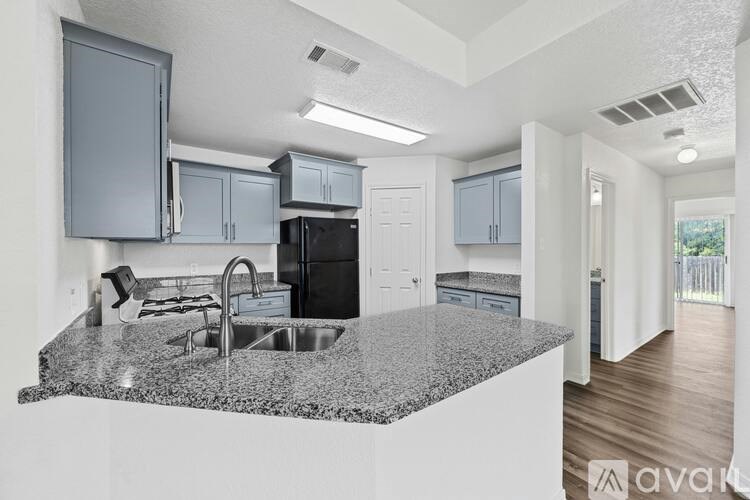 A kitchen with granite countertops and stainless steel appliances.