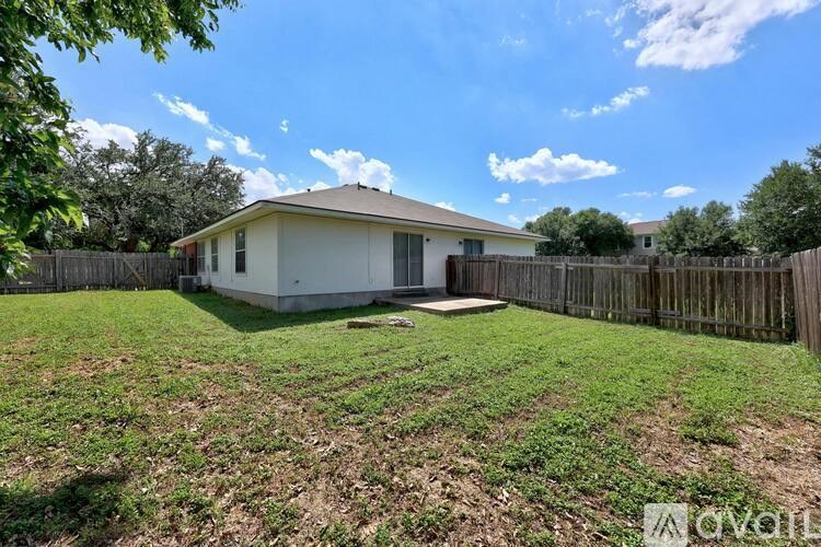 A house with a fenced yard is for sale.