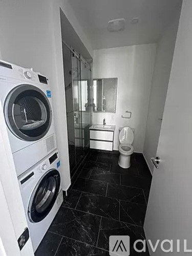 A washing machine and dryer are in a small laundry room.