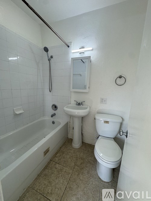 Two white front loading washing machines in a laundry room.