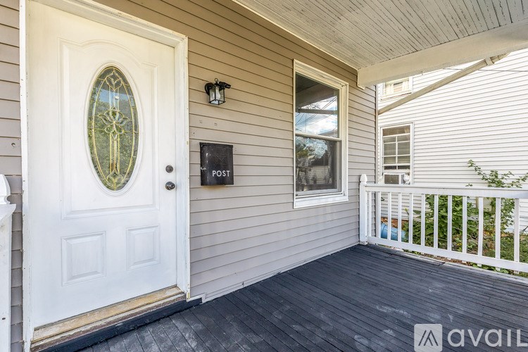 A white door with a glass window above a mailbox on a house.
