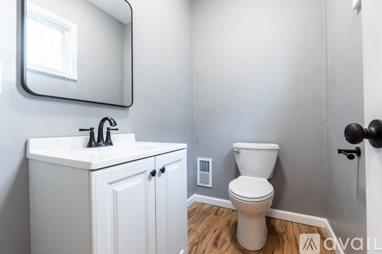 A white bathroom with a toilet and sink.