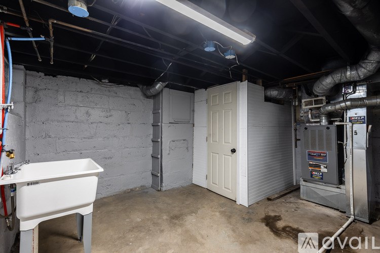A room with a white bathtub and a white door.
