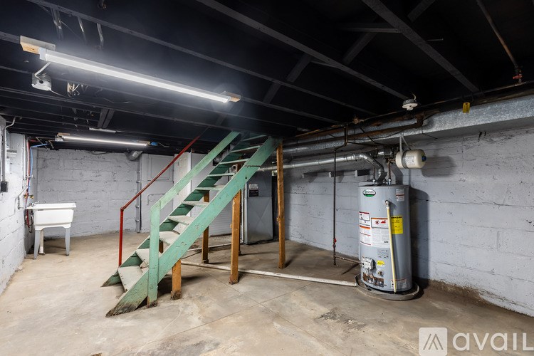 A room with a green staircase and a white piano.