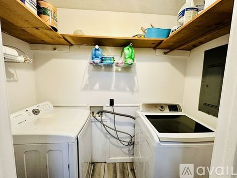 A small laundry room with a washer and dryer.