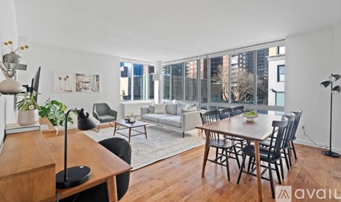 A living room with a dining table and chairs.