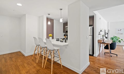 A white room with a desk and chairs.