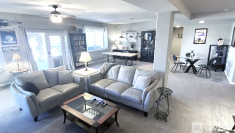 A living room with a grey sofa and a coffee table.