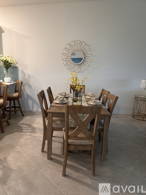 A dining room with a table set for four.