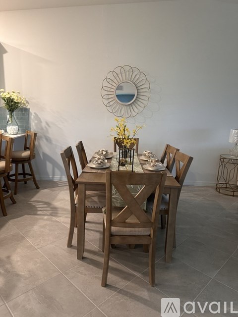 A dining room with a table set for four.