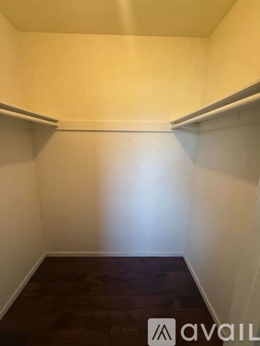 A room with white walls and a wooden floor.