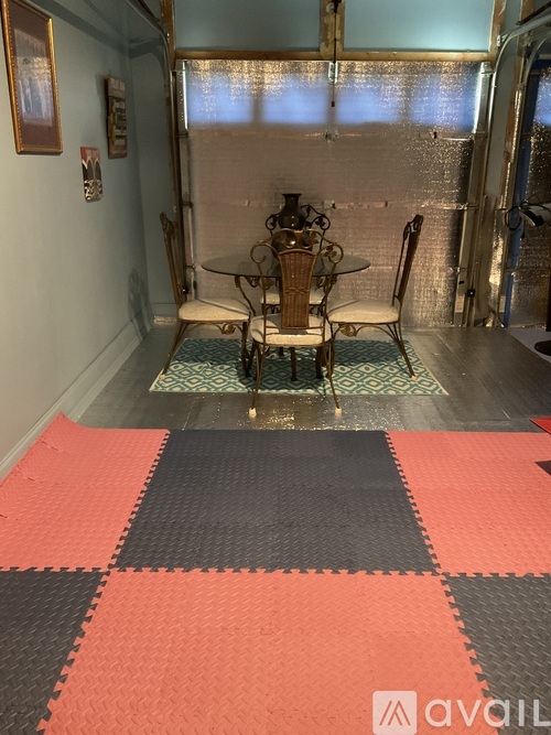 A dining room with a table and chairs.