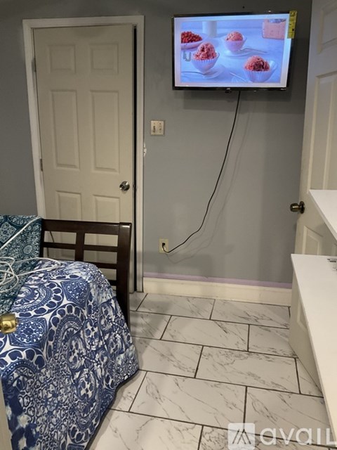 A bedroom with a bed and a television displaying a food program.