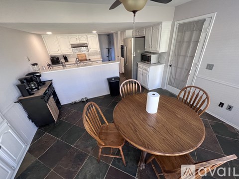 A kitchen with a table and chairs in the middle of the room.