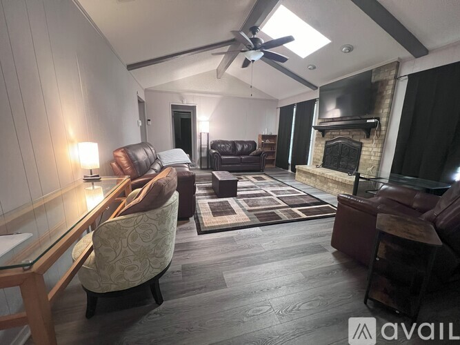 A living room with a fireplace and a television.