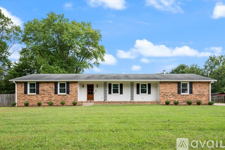 A house with a white door and windows is for sale.
